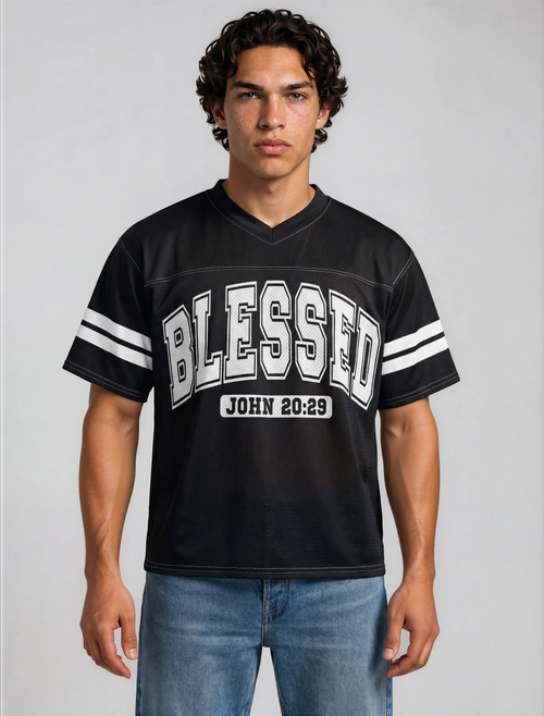 Man wearing a black sports jersey with 'BLESSED' and 'John 20:29' text on a gray background