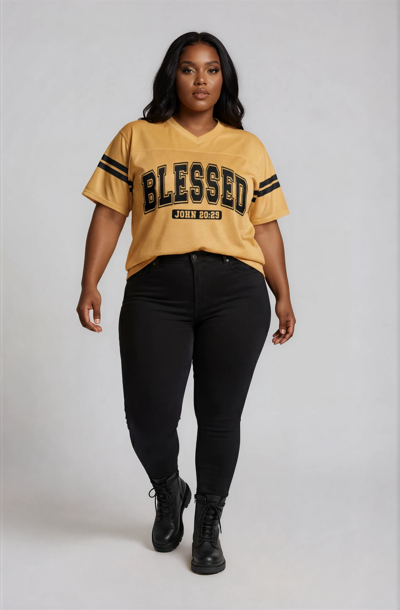 Woman wearing a yellow 'Blessed' t-shirt with black pants on a white background